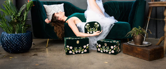 Frau auf Sofa mit luxuriösen Schmuckaufbewahrungsboxen von Wolf 1834 – stilvolle und sichere Aufbewahrung für hochwertigen Schmuck
